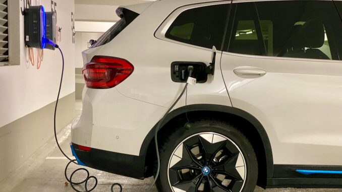 an electric car plugged in to a charging station