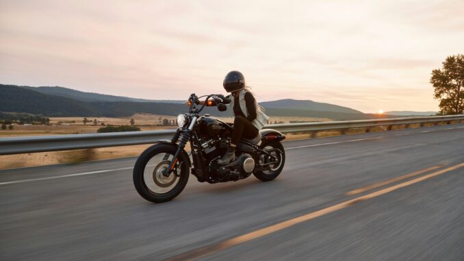 man on black cruiser motorcycle in highway