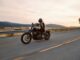 man on black cruiser motorcycle in highway