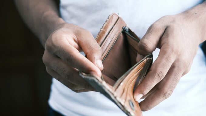 person holding brown leather bifold wallet