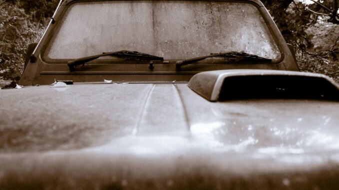 an old pick up truck parked in a wooded area