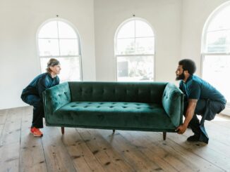 Two Men Carrying a Sofa