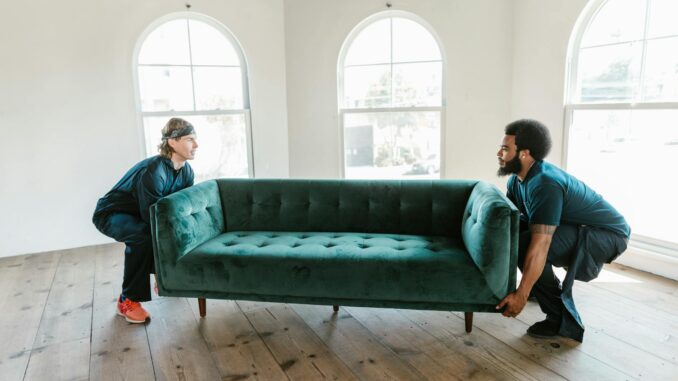 Two Men Carrying a Sofa